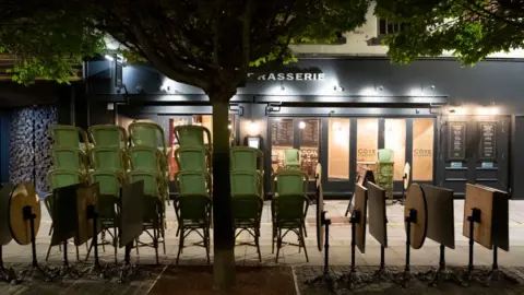 Getty Images Cardiff's Mill Lane deserted with chairs outside a restaurant