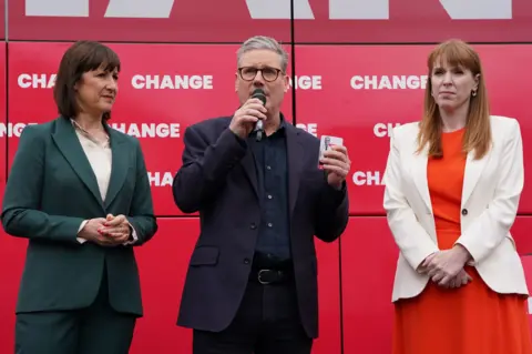 PA Media Shadow chancellor Rachel Reeves, Labour Party leader Sir Keir Starmer and deputy Labour leader Angela Rayner, at the launch event for Labour's campaign bus at Uxbridge College, west London