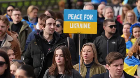 PA Media Ukraine protest in London with people holding placards as they march