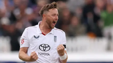 England bowler Ollie Robinson celebrates taking a wicket