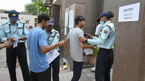 Hindustan Times via Getty Images Security personnel screens a candidate before entering the exam center to appear for NEET exam 2025 at Govt. Sarvodaya Girls/Boys Sr. Secondary School West Vinod Nagar, on May 4, 2025 in New Delhi, India.