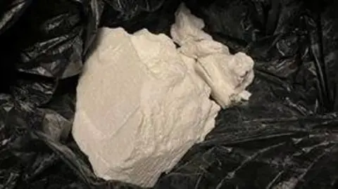 Wiltshire Police A large rock of a white substance in a black bag found during a drugs raid by Wiltshire Police