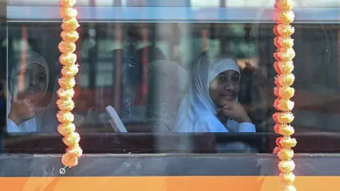 Getty Images School children gesture as they sit inside a coach of the Vande Bharat passenger train at the Srinagar railway station in Srinagar on June 6, 2025, ahead of the inauguration of the Kashmir rail link by Indian Prime Minister Narendra Modi.