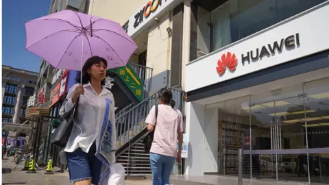 Getty Images People walk past a Huawei store on July 1, 2019 in Dongdaqiao, Chaoyang District, Beijing.