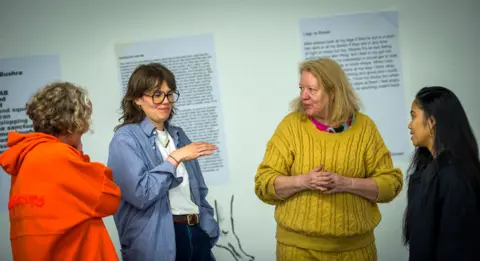 Actors Penny Layden, Inés de Clercq, Calire Barstow and Malanie-Joyce Bermudez rehearse part of 'All The Rage' in the repurposed office space. Poetry is posted around the walls in the background