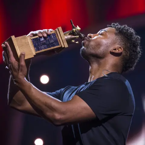 Getty Images John Lundvik winning a trophy for Sweden