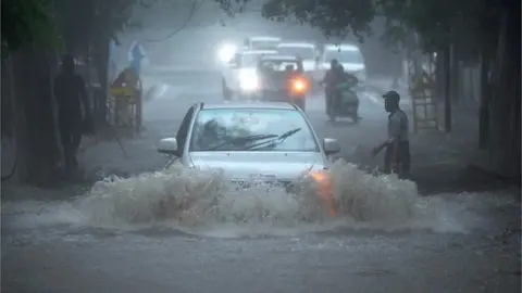 Getty Images Vehicles wade through a Waterlogged stretch under a railway bridge near Sarojini Nagar during monsoon rain on July 9, 2023 in New Delhi, India.