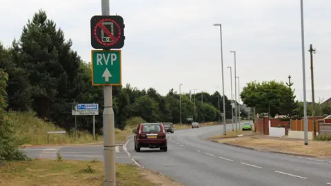 Norfolk County Council Mobile phone warning sign