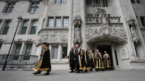 Getty Images Supreme Court Justices process from the Supreme Court to Westminster Abbey on 1 October, 2013 in London