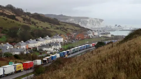 PA Media Lorries queue for The Port of Dover along the A20 in Kent as the Dover TAP (Traffic Access Protocol) is implemented due to high volumes of freight traffic