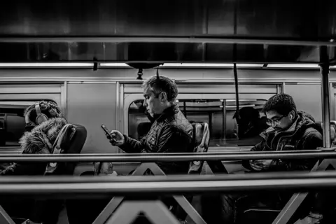 Kevin Sivakumar People on a bus using mobile phones