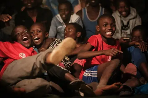 AFP Kenyan children watch the Qatar 2022 World Cup Group A football match between Qatar and Ecuador at a public screening at Camp Toyoyo Ground in Nairobi, on November 20, 2022