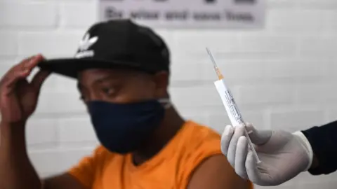 Getty Images A volunteer receives an injection from a medical worker during the country's first human clinical trial for a potential vaccine against Covid-19 at the Baragwanath Hospital on 28 June 2020 in Soweto, South Africa