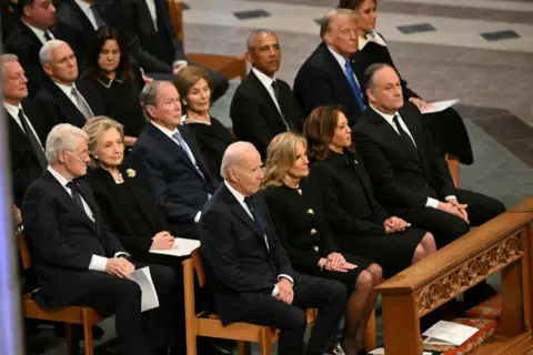 Donald Trump sits among his political rivals, including former president Barack Obama and Vice-President Kamala Harris, during Jimmy Carter's funeral service.