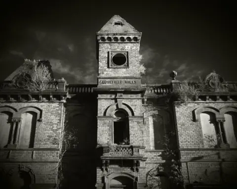 Geoff Piltz A black and white slightly eerie image of the brick front of the Rosefield Mills building
