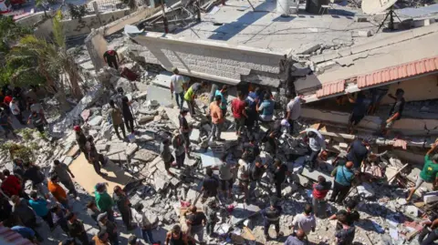 Getty Images Rescuers searched for survivors of the strike on the al-Nasr School in Gaza City