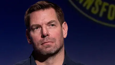 Eric Swalwell wears a dark blue button down shirt at a candidate forum in Los Angeles last year.