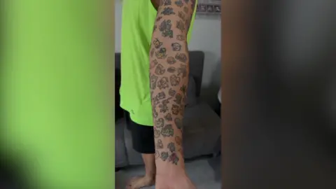 An covered in small Pokemon tattoos