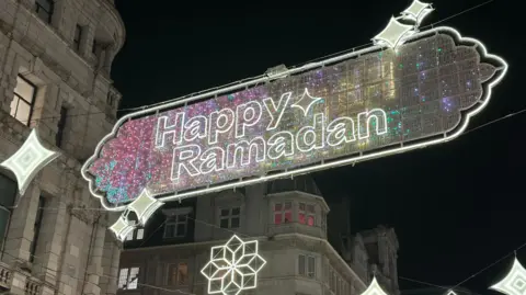 Festive lighting hung in central London with the wording Happy Ramadan.