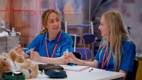 Big Mountain Productions/BBC Tilly explaining the diabetes equipment to Natalie