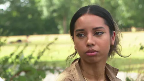 Zahra, a young woman, looking at the camera.