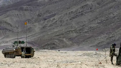 Getty Images This picture taken on May 19, 2024, shows an armoured vehicle of the Indian army at a military camp in Eastern Ladakh. Lines on a map once meant little to India's Tibetan herders of the high Himalayas, expertly guiding their goats through even the harshest winters to pastures on age-old seasonal routes. That stopped in 2020, after troops from nuclear-armed rivals India and China clashed in bitter hand-to-hand combat in the contested high-altitude border lands of Ladakh. (Photo by TAUSEEF MUSTAFA / AFP) (Photo by TAUSEEF MUSTAFA/AFP via Getty Images)