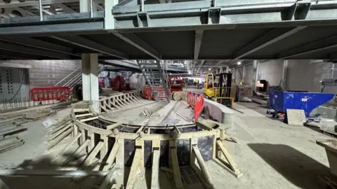 Tom Holdsworth/Leeds Bradford Airport Construction in terminal, a ladder, planks of wood and machinery are in view