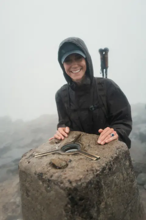 X/KensingtonRoyal Catherine stands in a raincoat the summit of Ben Nevis