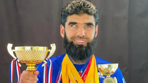 Wali Noori Wali with trophies and medals