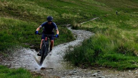 Jamie Cox on a training ride through rough terrain