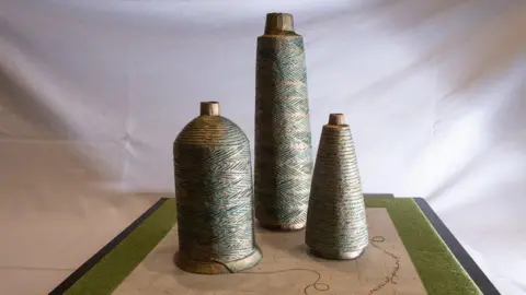 Derry and Strabane Council A scale model of a new artwork, showing three spools of cotton standing side by side