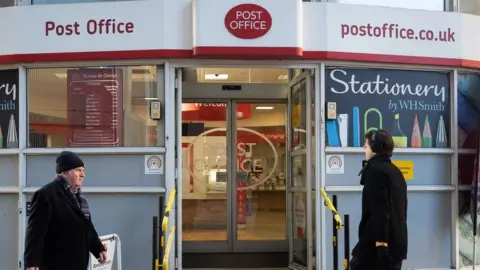 Getty Images People walking past a Post Office branch