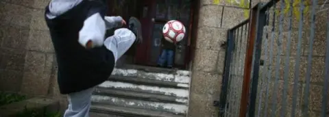 Getty Images Boy kicking ball