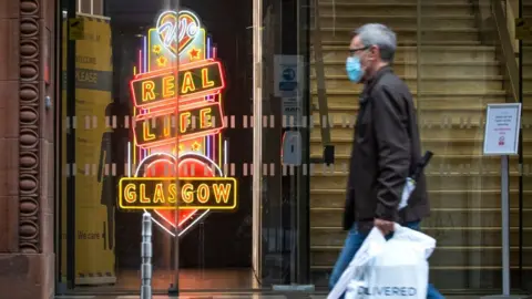 PA Media Man walking in Glasgow