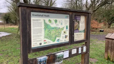 Luke Deal/BBC An information sign at Knettishall Heath Nature Reserve