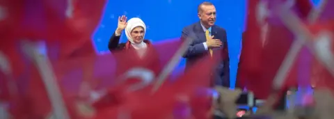 Getty Images Turkish President Recep Tayyip Erdogan and his wife Emine Erdogan wave during a pre-election rally in Sarajevo, on May 20, 2018