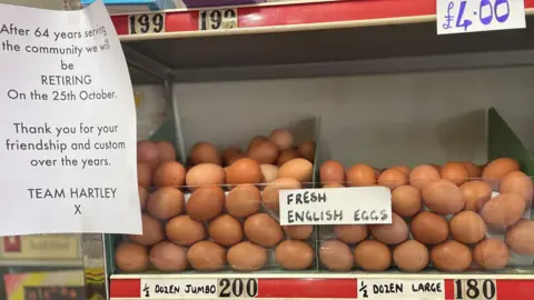 Simon Thake/BBC Eggs, loose in a large plastic container, sit on a red and chrome shelf