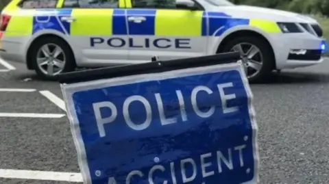 A police car behind a sign that says 'police incident'.