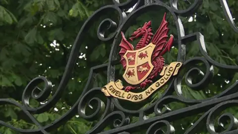 Llandovery College crest on iron school gate, with motto