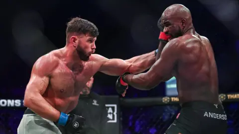 Karl Moore is punched by Corey Anderson