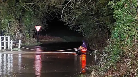 Driver on submerged car roof