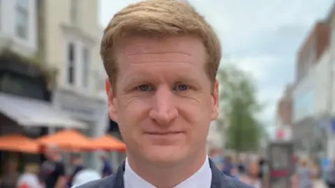 Matthew Scott Matthew Scott standing in a busy street