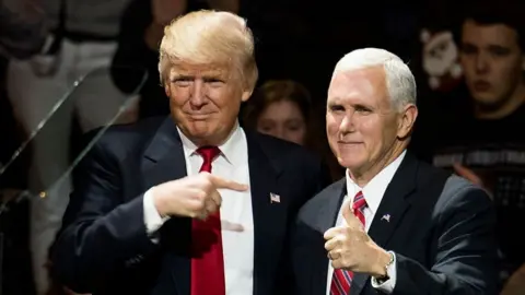 Getty Images President Donald Trump points at Vice President Mike Pence at stage in 2016.