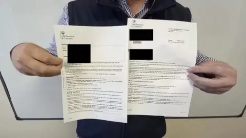 Anonymous An anonymous Apostle Client seen here holding up a repayment notice from HMRC