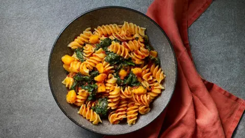 A plate of giant fusilli with cavolo nero and 'nduja