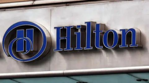 A blue Hilton Hotel sign
