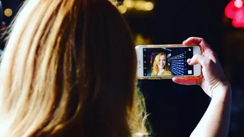 Getty Images woman taking selfie