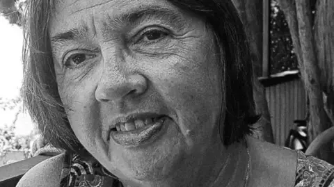 Shrewsbury Town FC A black-and-white image of Pam Coe. She has dark hair and is looking at the camera