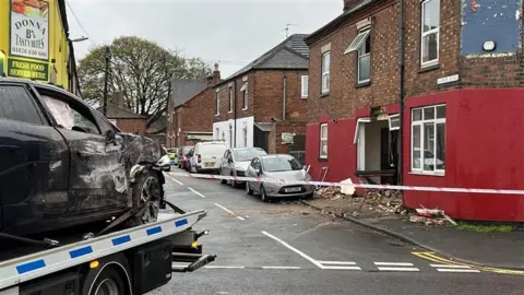 Aftermath of car crashing into house on Currie Road in Newark