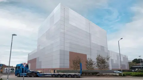 An artist's impression submitted as part of a planning application for a new building at a facility in Stafford. It shows a large building with a lorry in front of it.